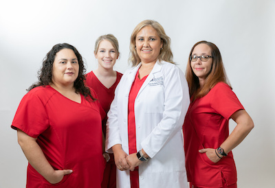 Picture of a female Physician and three female Nurses smiling.