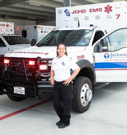 Jackson County Hospital District EMS Ambulance and two EMS Staff (one female and one male).